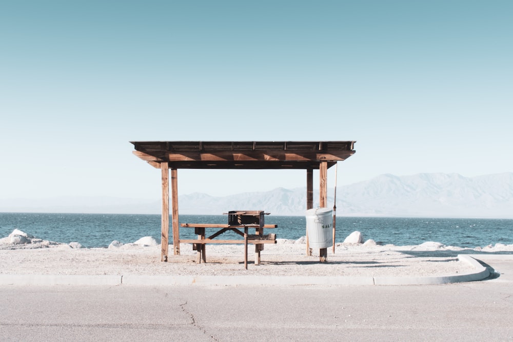 brown wooden beach dock on white sand beach during daytime