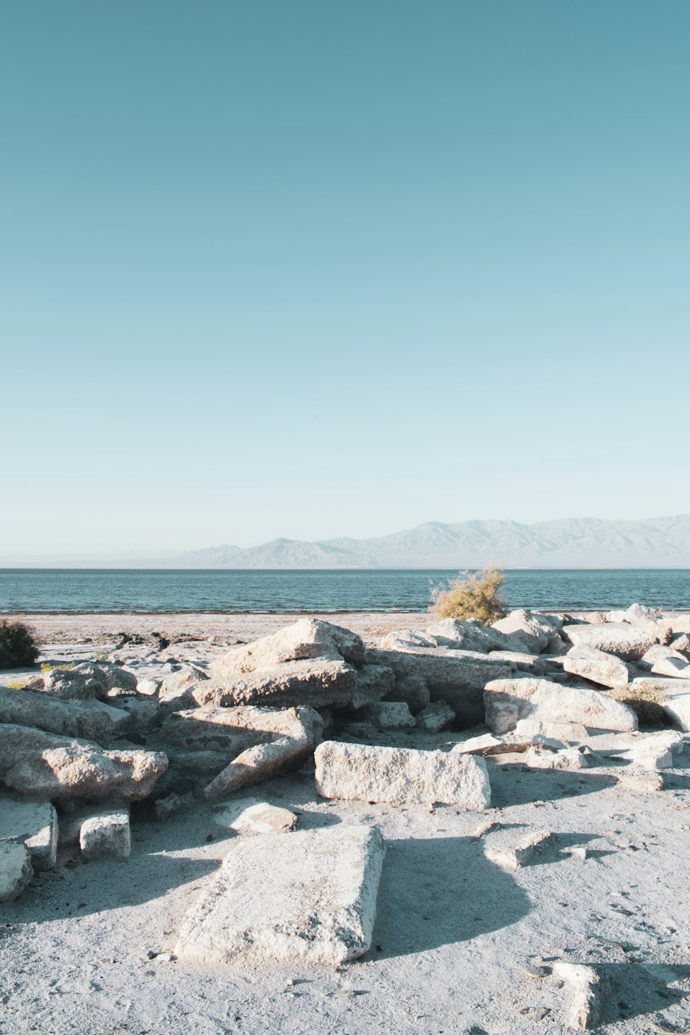 gray rocks near body of water during daytime