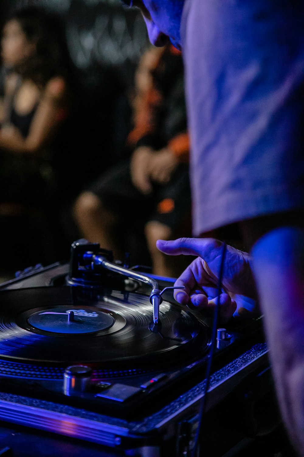 person playing dj turntable in grayscale photography