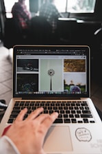 person using macbook pro on table