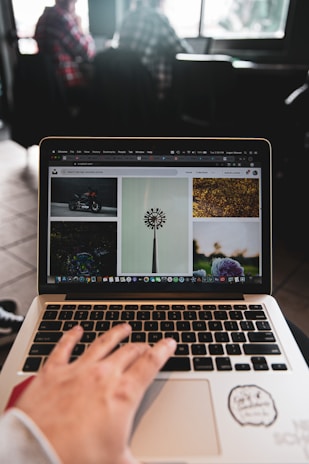 person using macbook pro on table