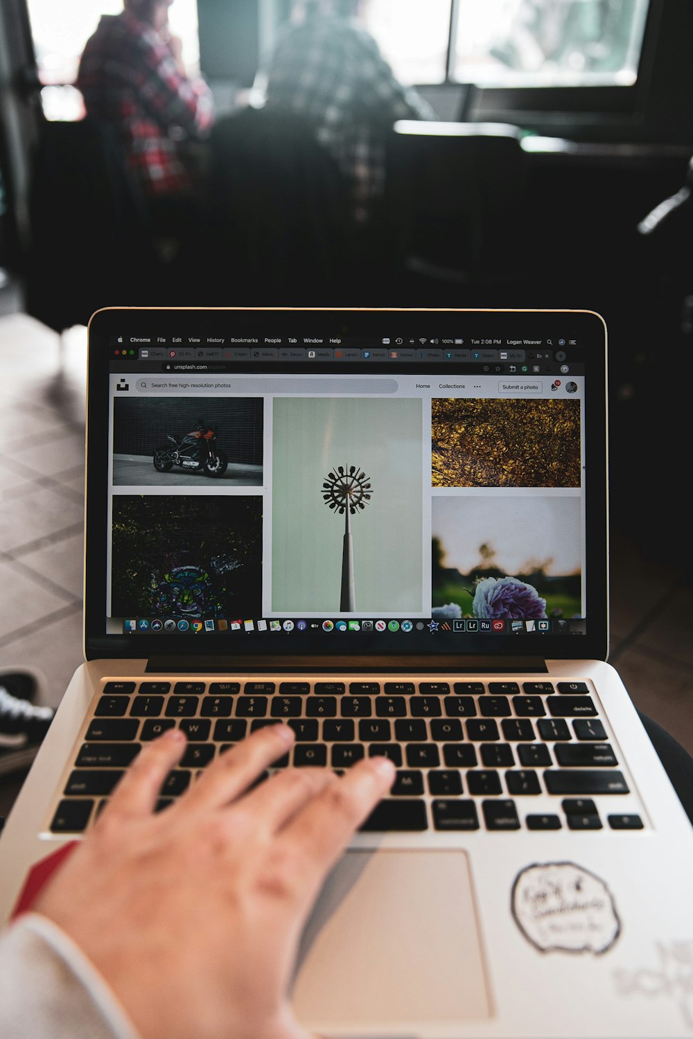 person using macbook pro on table