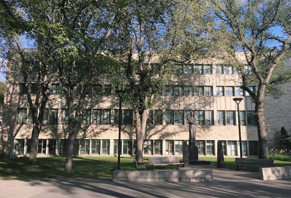 green trees near white concrete building during daytime