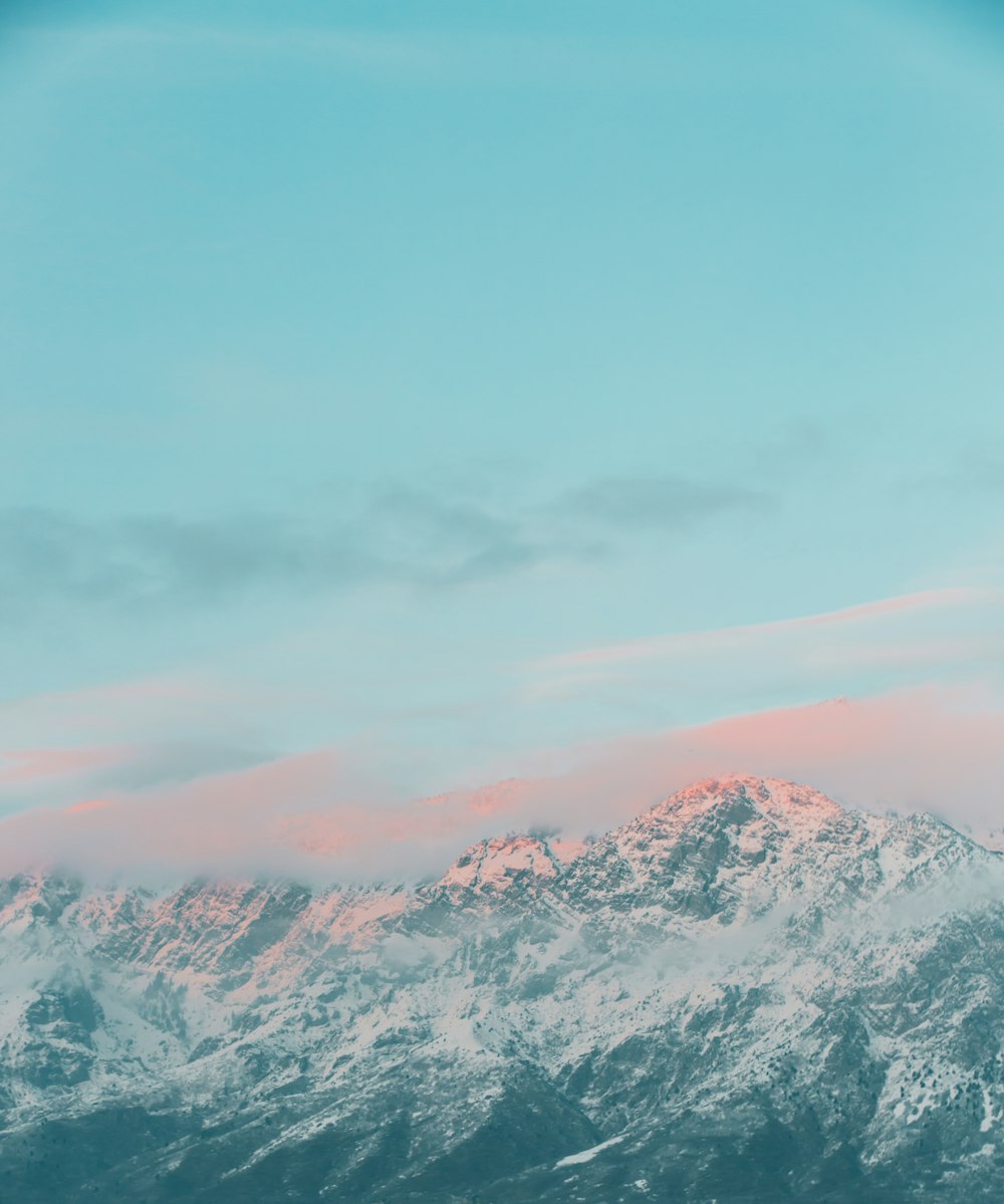 snow covered mountain under cloudy sky during daytime