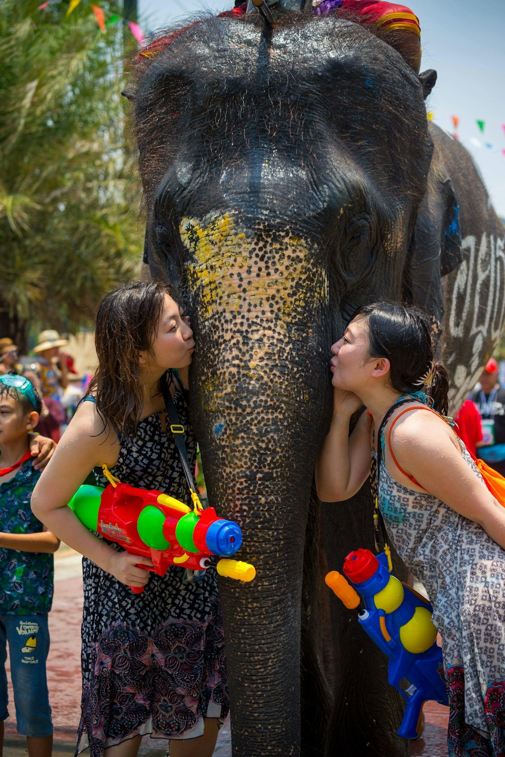 woman in green and white tank top holding yellow and orange plastic toy gun