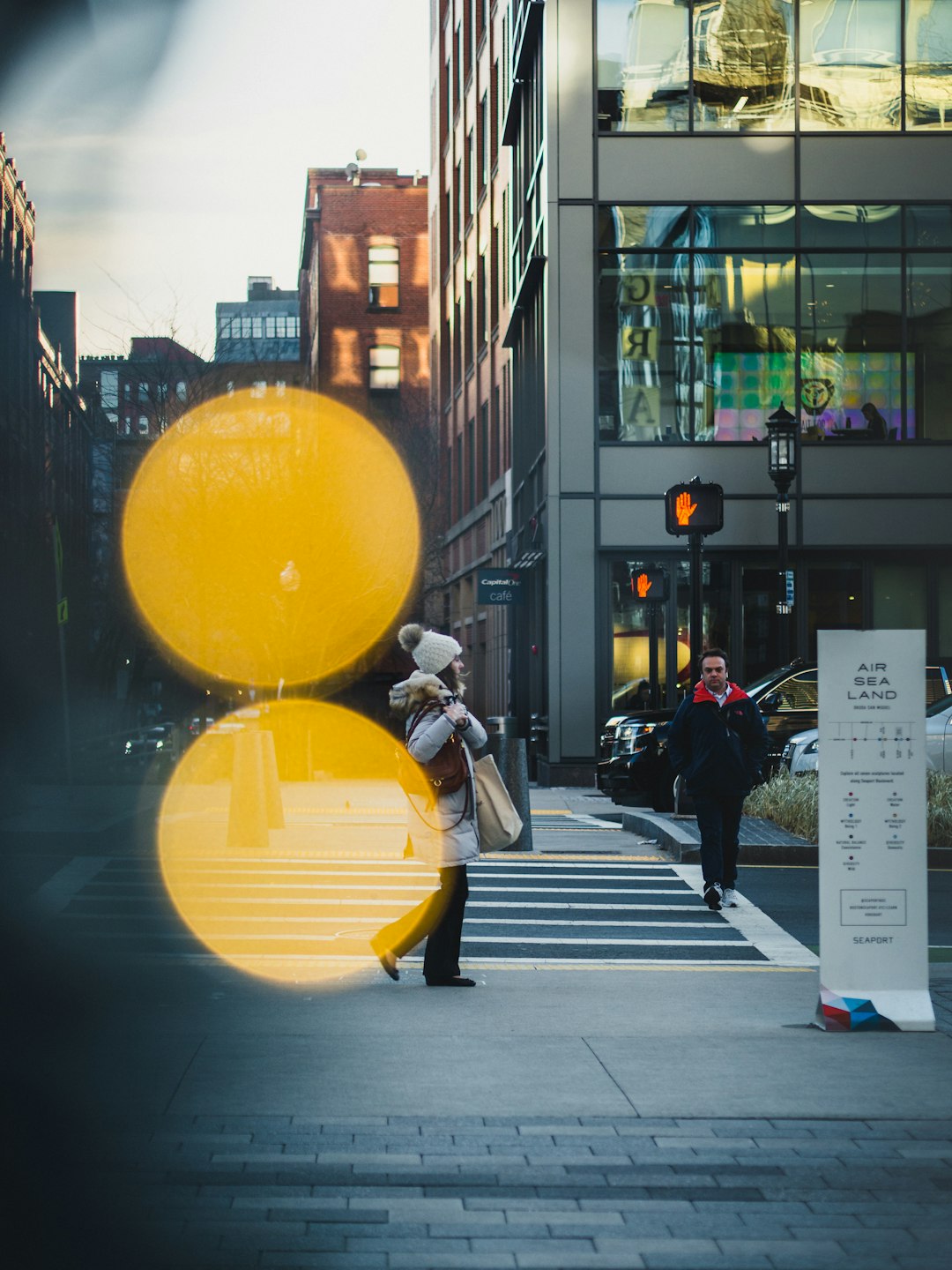 man in black jacket and yellow pants sitting on black motorcycle during daytime