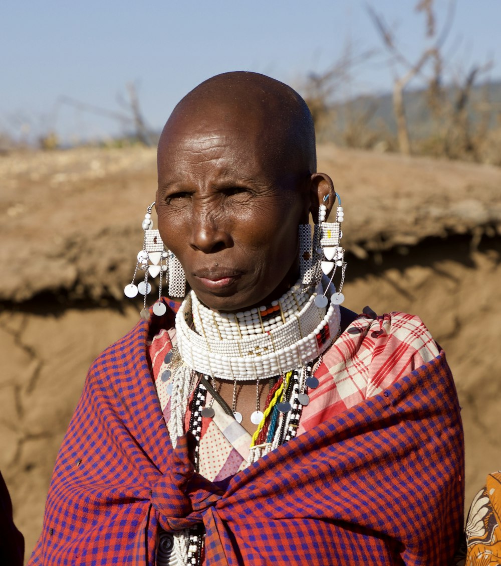 woman in red and blue plaid shirt wearing white scarf