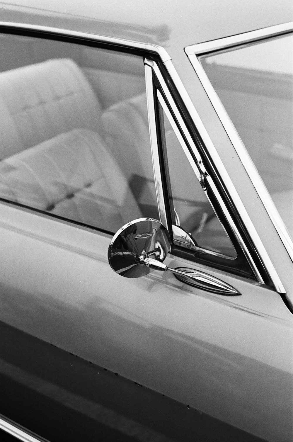 grayscale photo of car side mirror