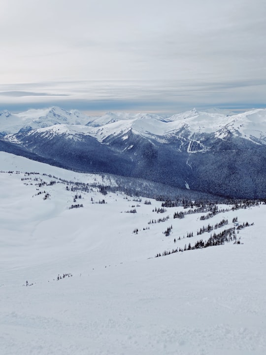 snow covered mountain under cloudy sky during daytime in Whistler Mountain Canada