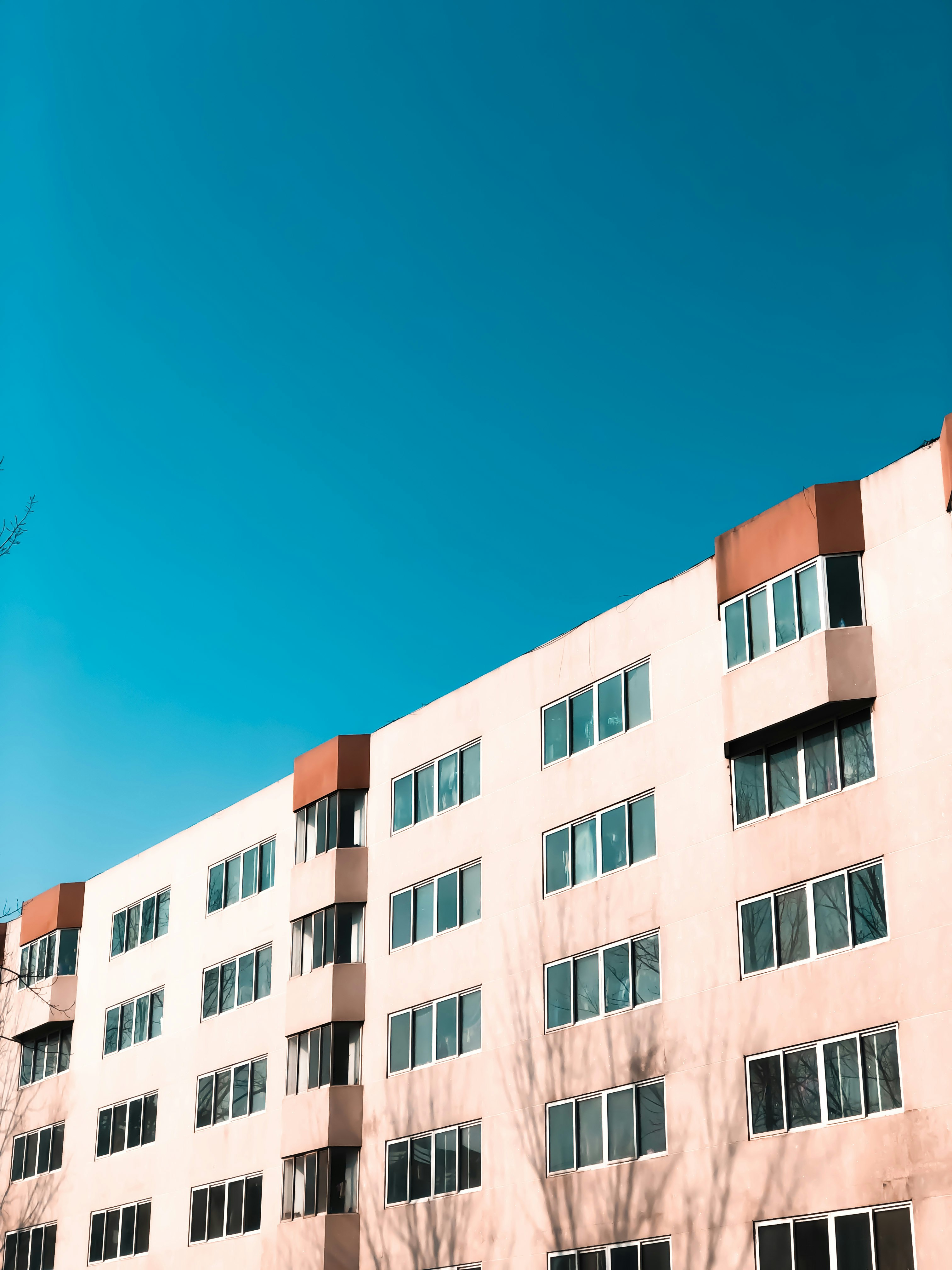 brown and white concrete building under blue sky during daytime