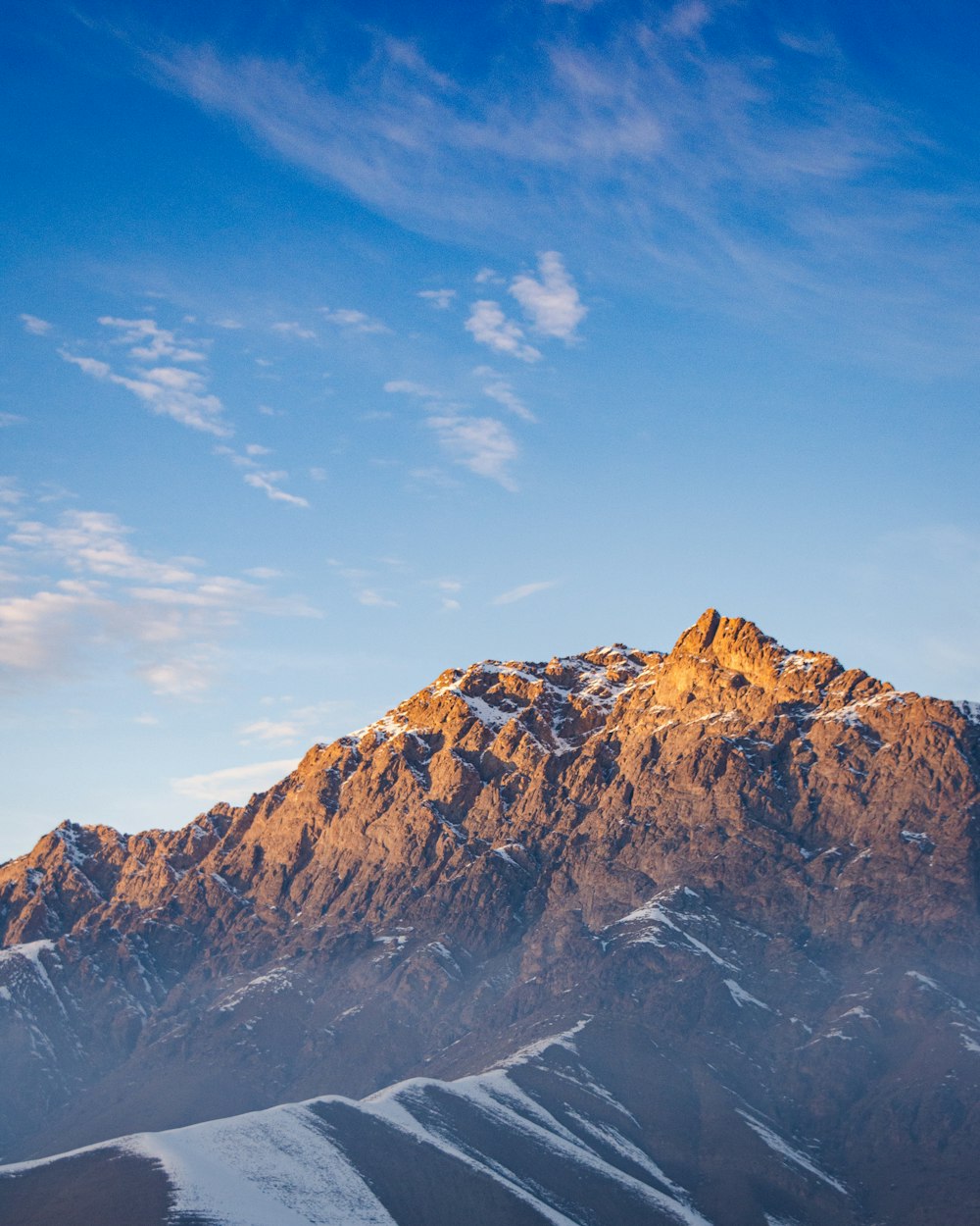 brown rocky mountain under blue sky during daytime