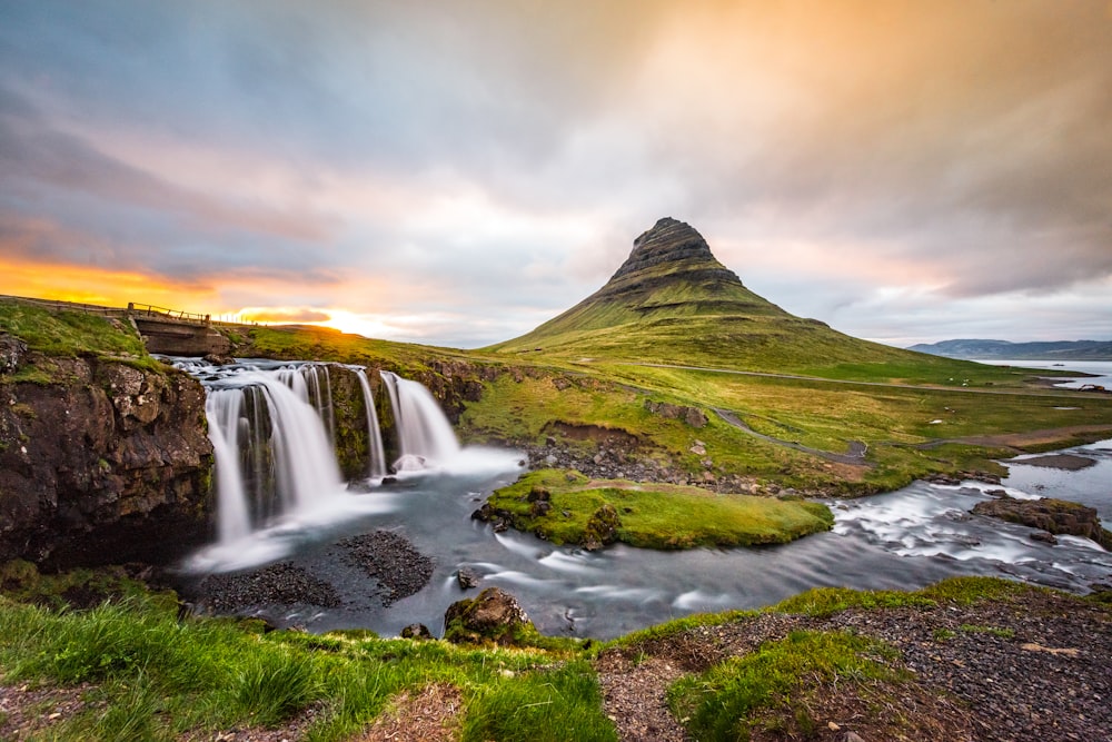 waterfalls in the middle of green mountain