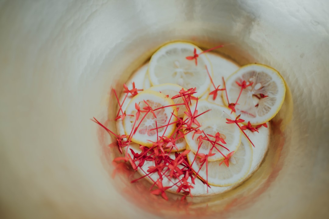 red and white round fruits in clear glass bowl