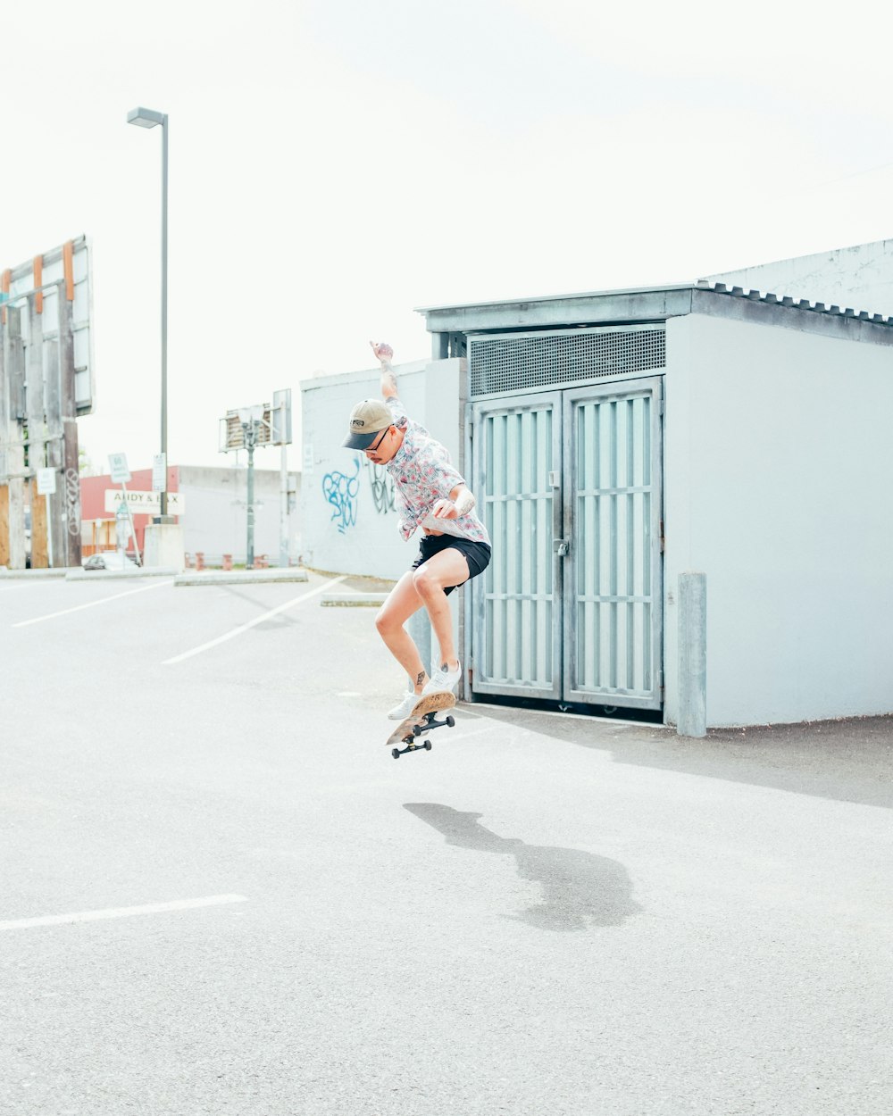 woman in white t-shirt and red shorts running on road during daytime