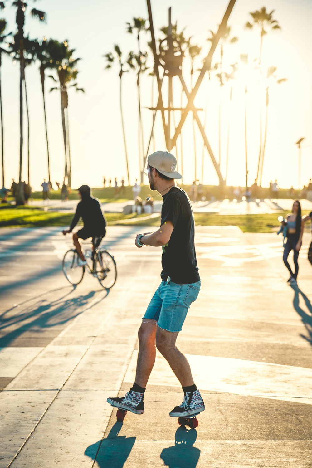 man in black t-shirt and blue denim shorts riding bicycle on brown wooden dock during
