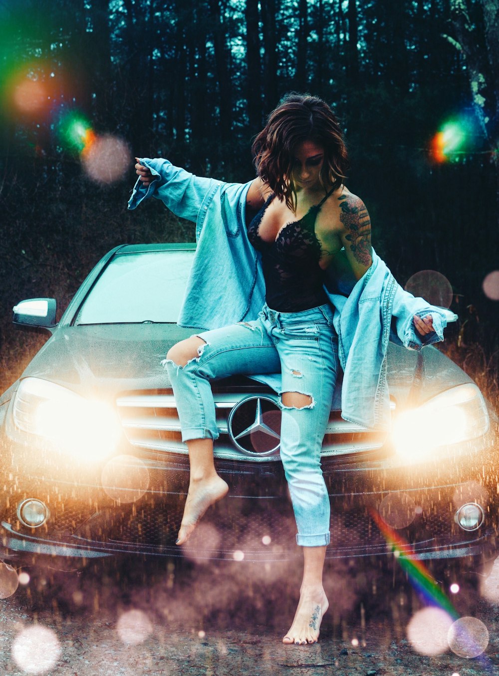 woman in blue denim jacket and white pants sitting on white car during nighttime