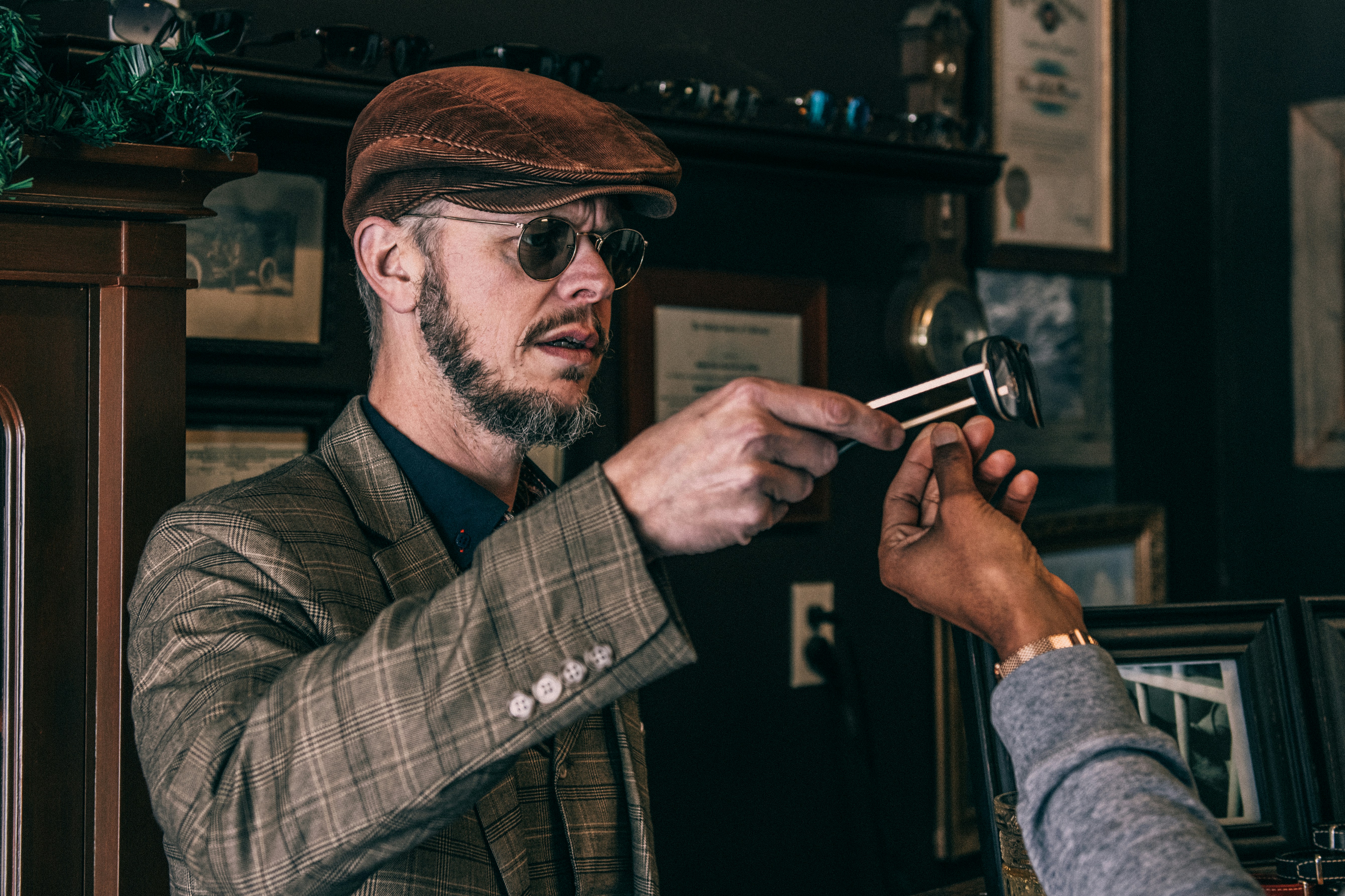 man in black and white plaid button up shirt holding black smartphone