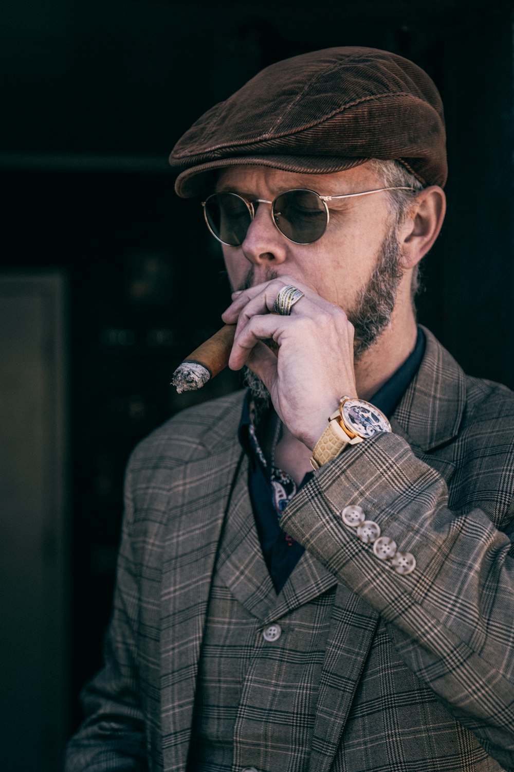 man in black and white plaid coat wearing black sunglasses