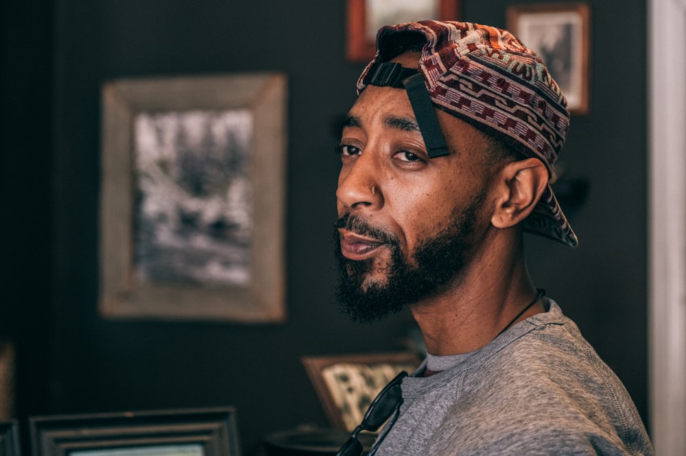 man in gray crew neck shirt wearing brown and white bandana