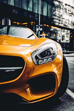 yellow porsche 911 parked on street during daytime