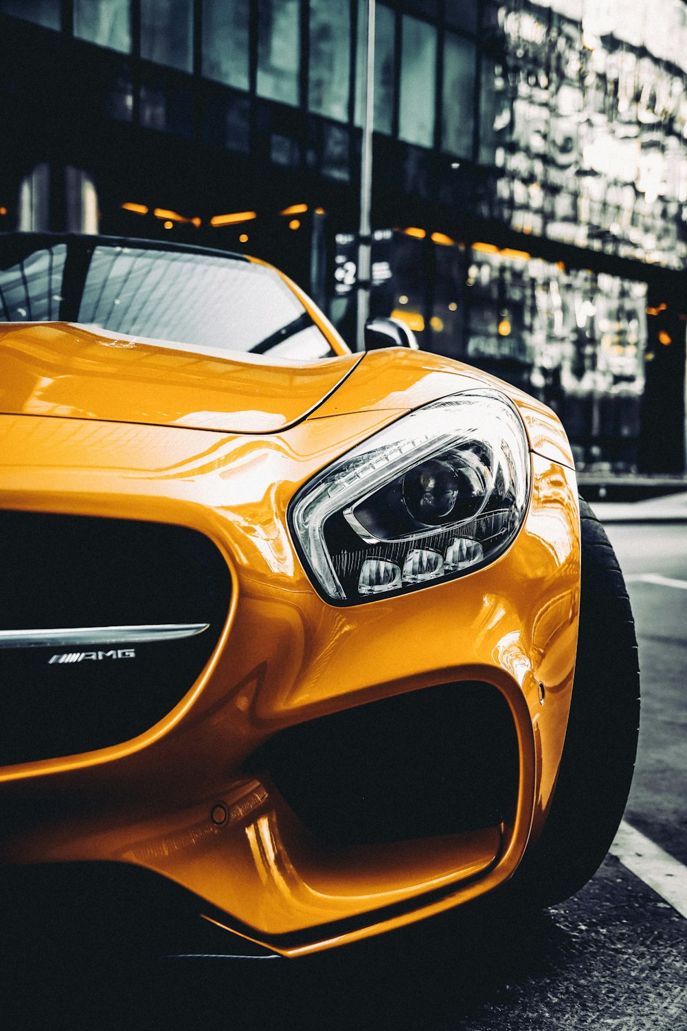 yellow porsche 911 parked on street during daytime