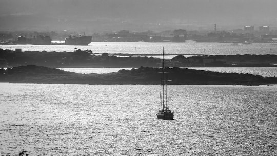 grayscale photo of boat on sea in Olbia Italy