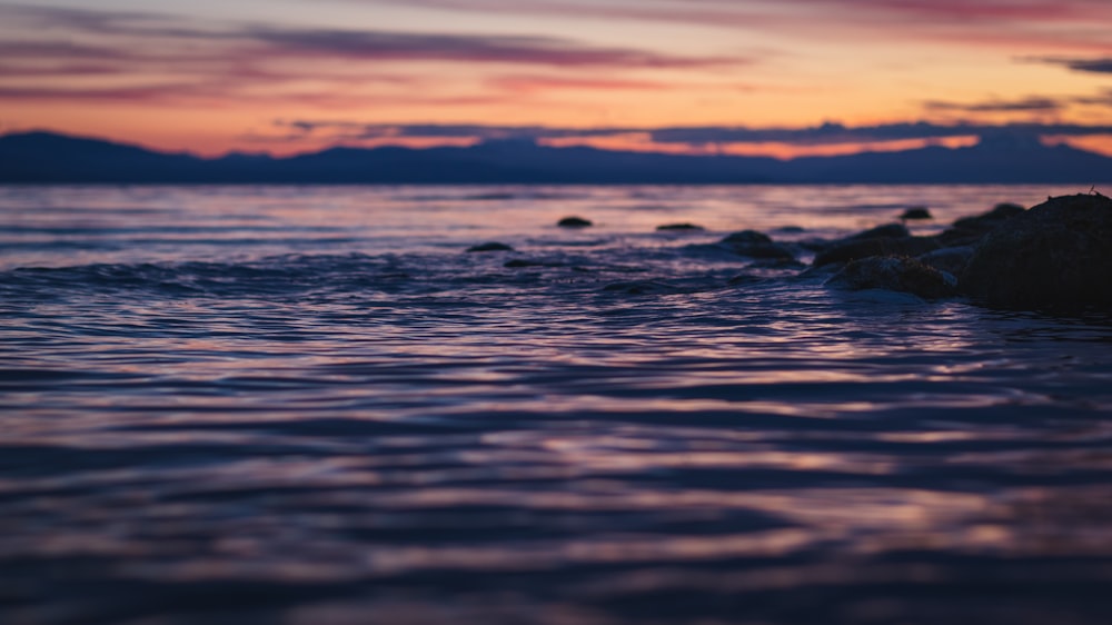 body of water during sunset