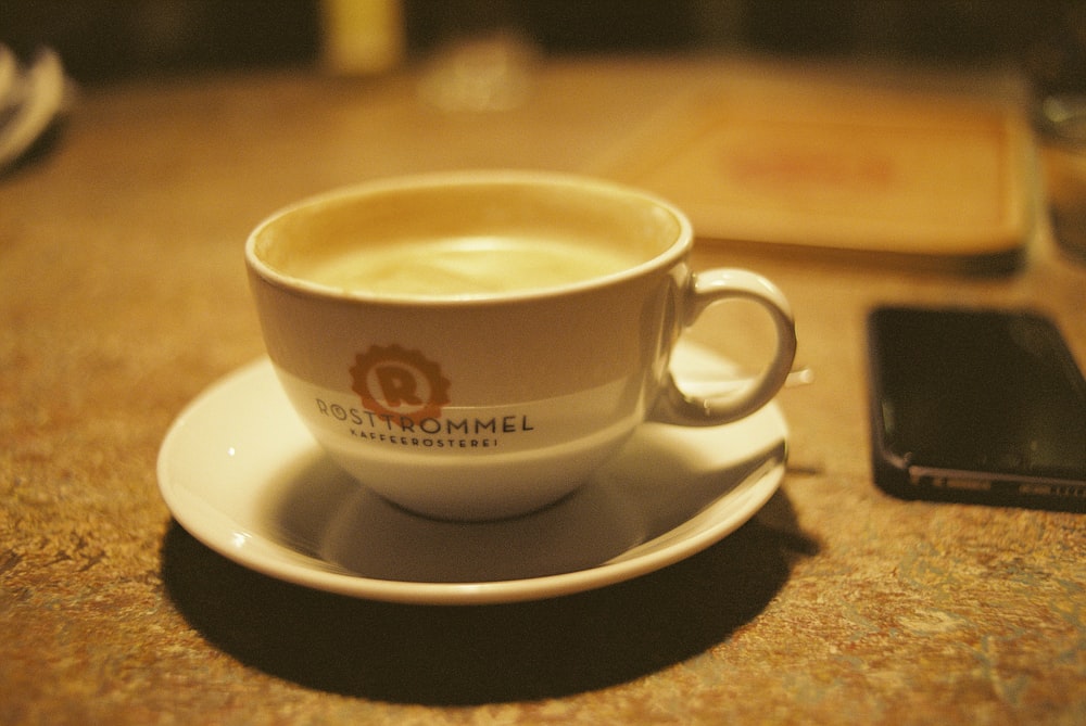 white ceramic cup on white saucer