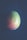 A single mango with a smooth texture and a mix of green, yellow, and orange-red hues rests against a dark, textured background. The lighting creates a soft, natural look with subtle shadows.