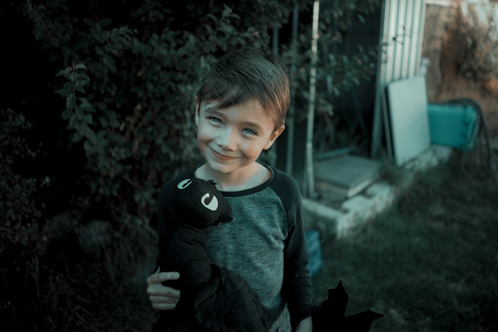 boy in blue and gray long sleeve shirt