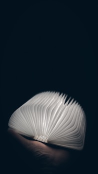 An open book glowing softly, representing knowledge and life purpose.