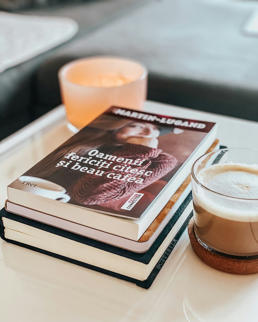 brown and white coffee cup on white and brown book