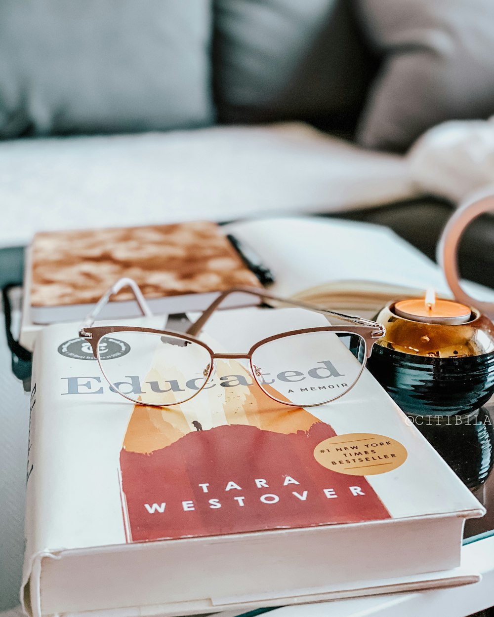 brown and white ceramic mug on white and red book