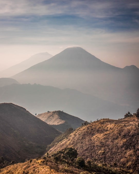 brown and green mountain under white clouds during daytime in Gunung Prau Indonesia