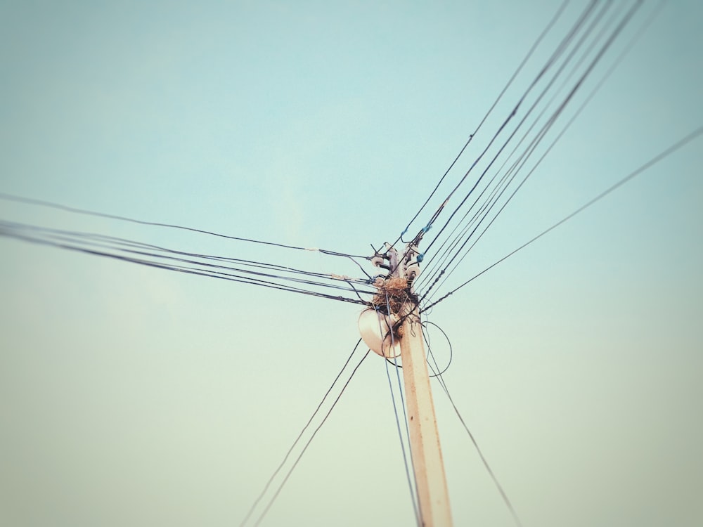 brown electric post under blue sky during daytime