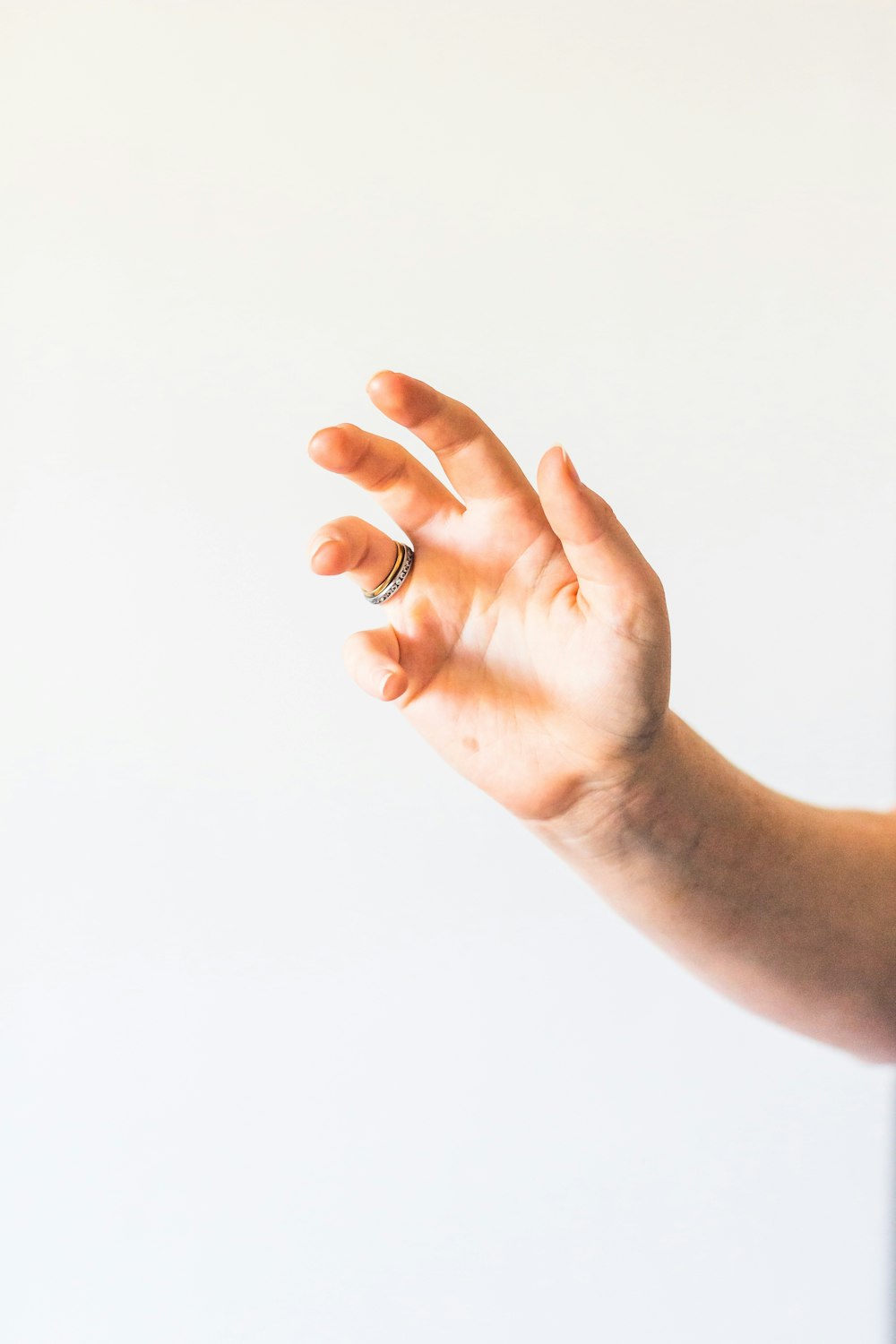 person holding silver ring on right hand