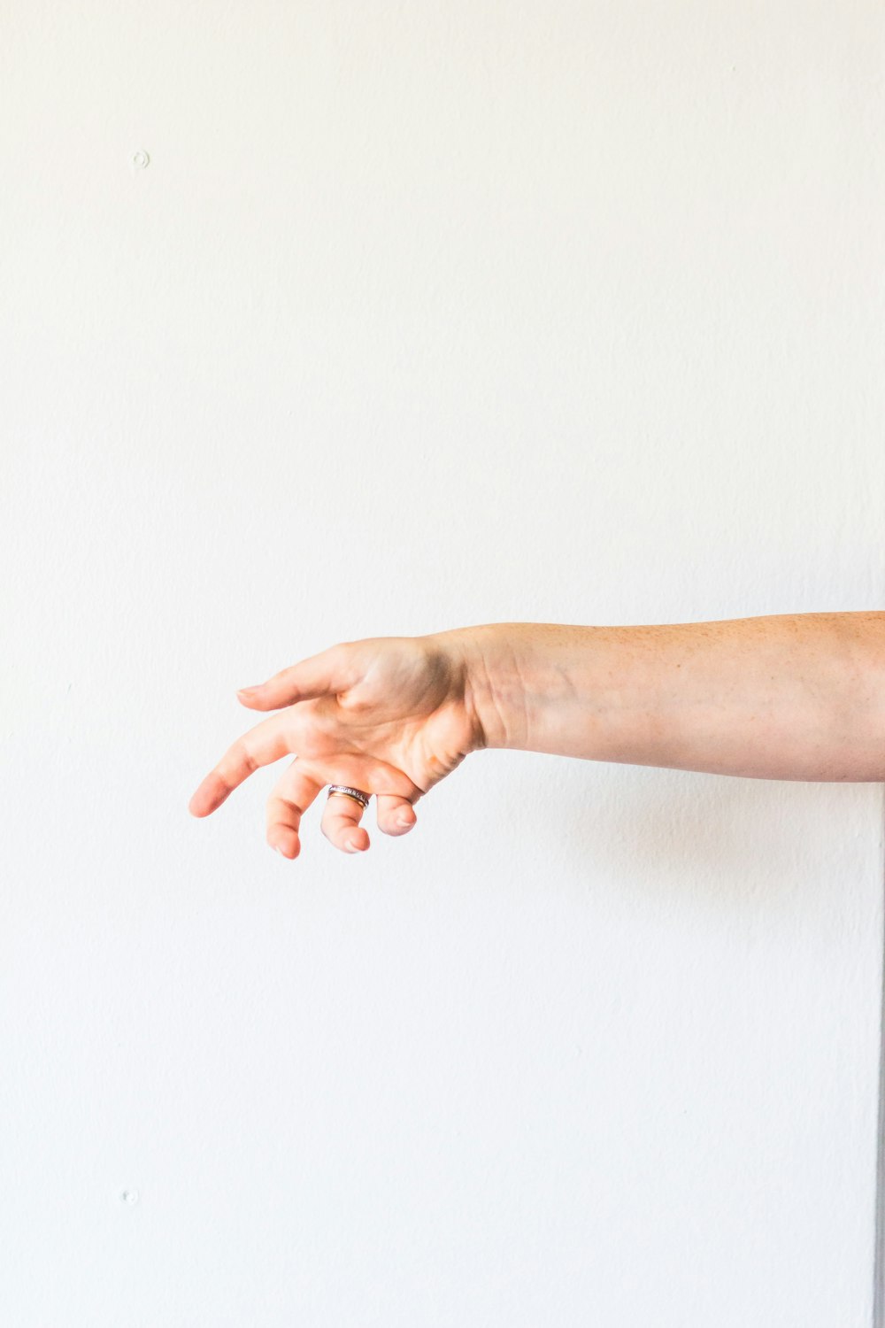 persons hand on white surface