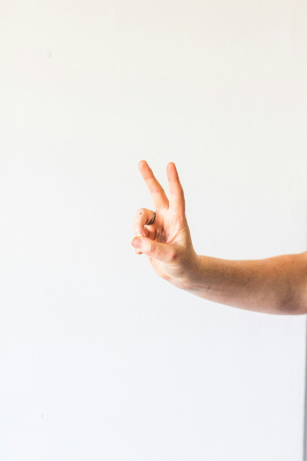 persons left hand doing thumbs up sign