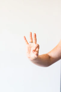 persons hand doing thumbs up