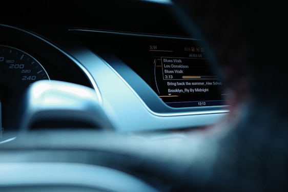 A sleek dark-themed dashboard showing an artist uploading a song with album artwork and metadata fields.