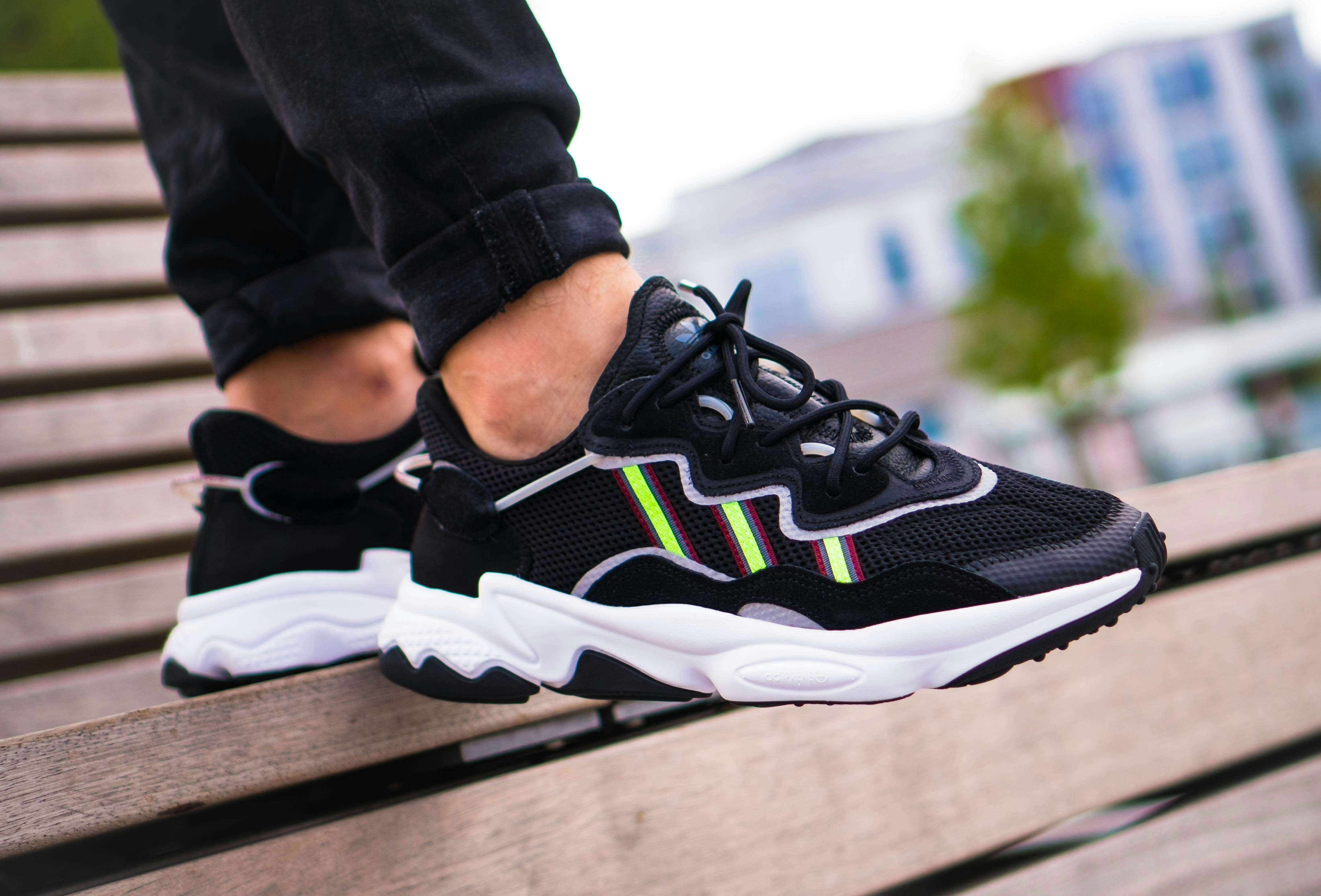 person wearing black and white nike running shoes footwear teams background