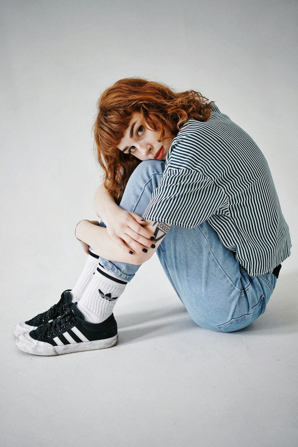 woman in black and white striped long sleeve shirt and blue denim jeans