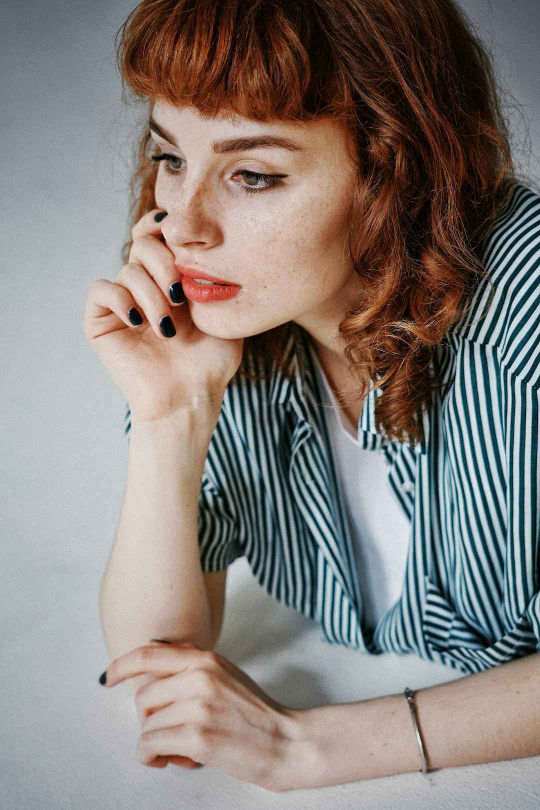 woman in white and black striped dress shirt