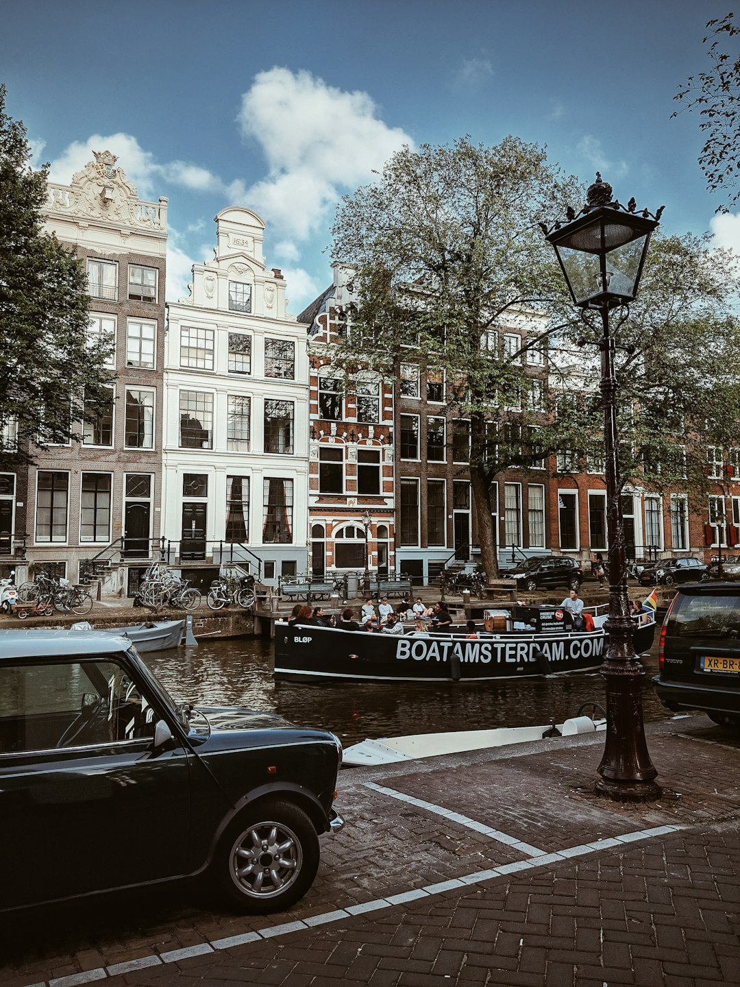 black car parked beside brown concrete building during daytime