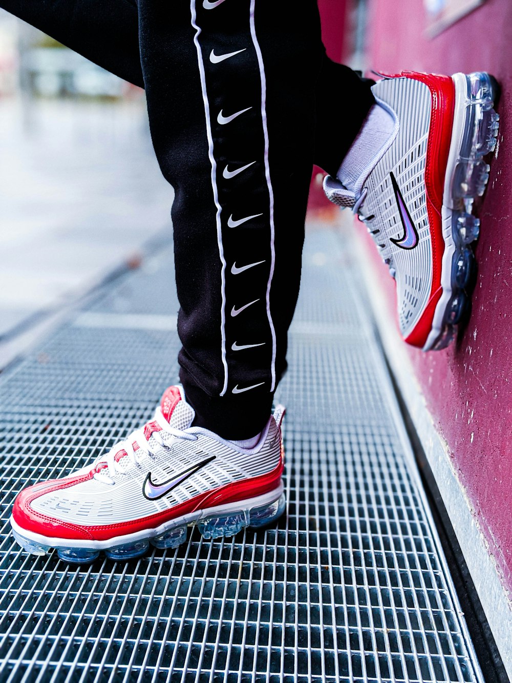 person in black pants wearing red and white nike sneakers photo – Free  Image on Unsplash