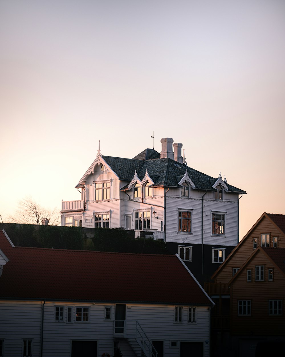 white and brown concrete house under gray sky