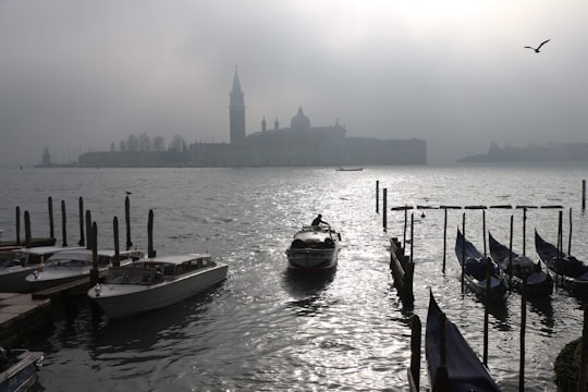 black and white boat on body of water during daytime in Church of San Giorgio Maggiore Italy