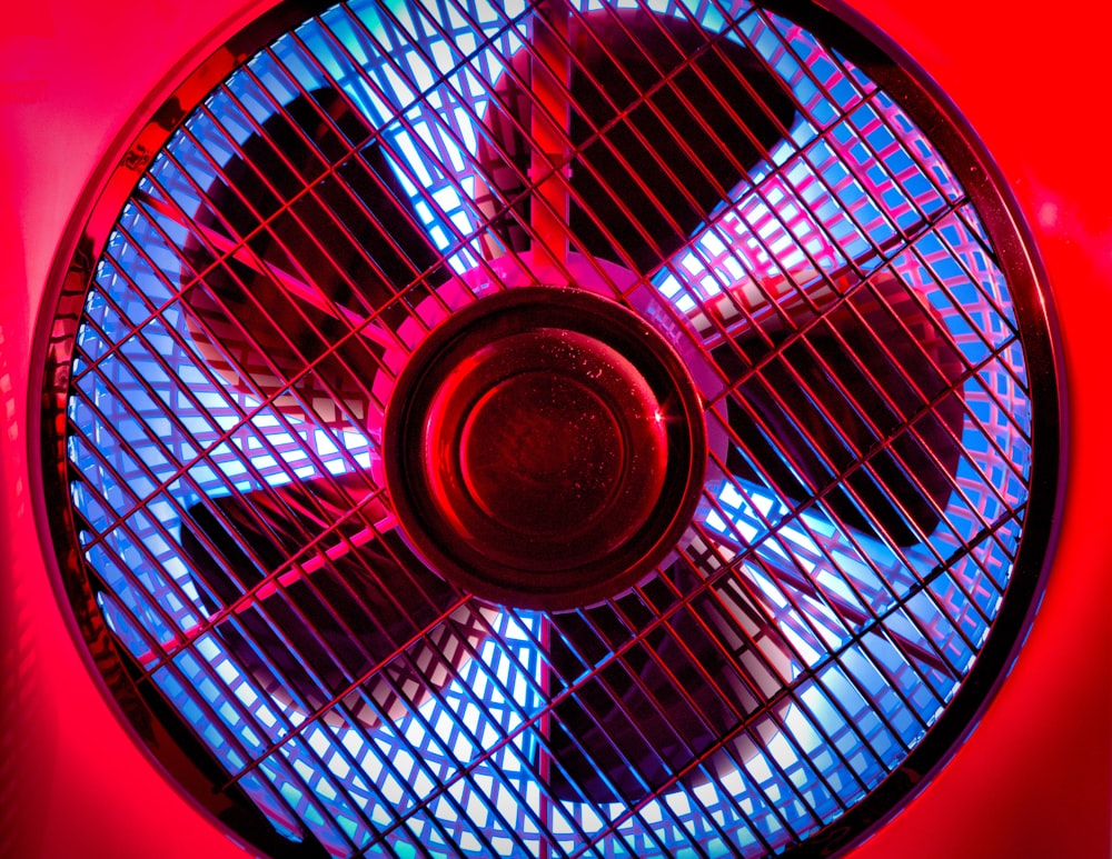 black and gray fan on brown wooden table