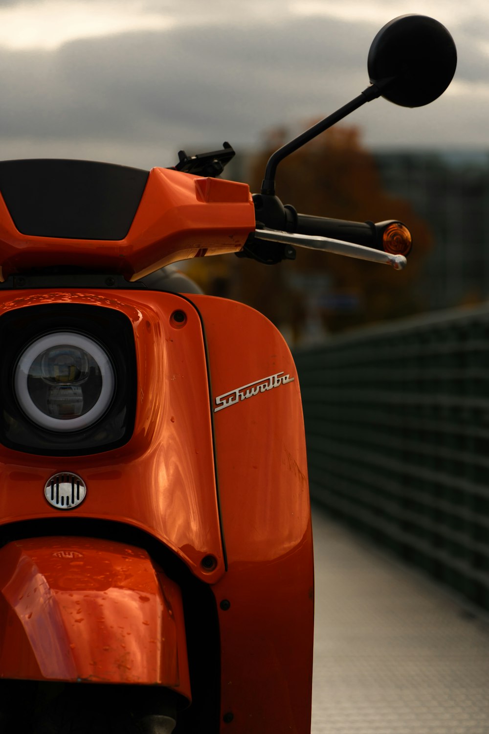 orange and black motorcycle in close up photography