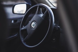A close-up of a driving test in progress with an instructor and a student in a car.